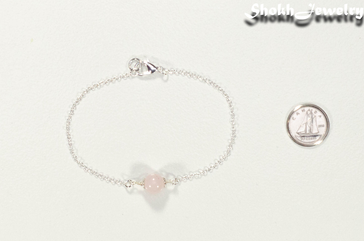 Minimal Rose Quartz Bracelet beside a dime.