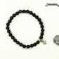 6mm Black Obsidian Bracelet with Initial beside a dime.