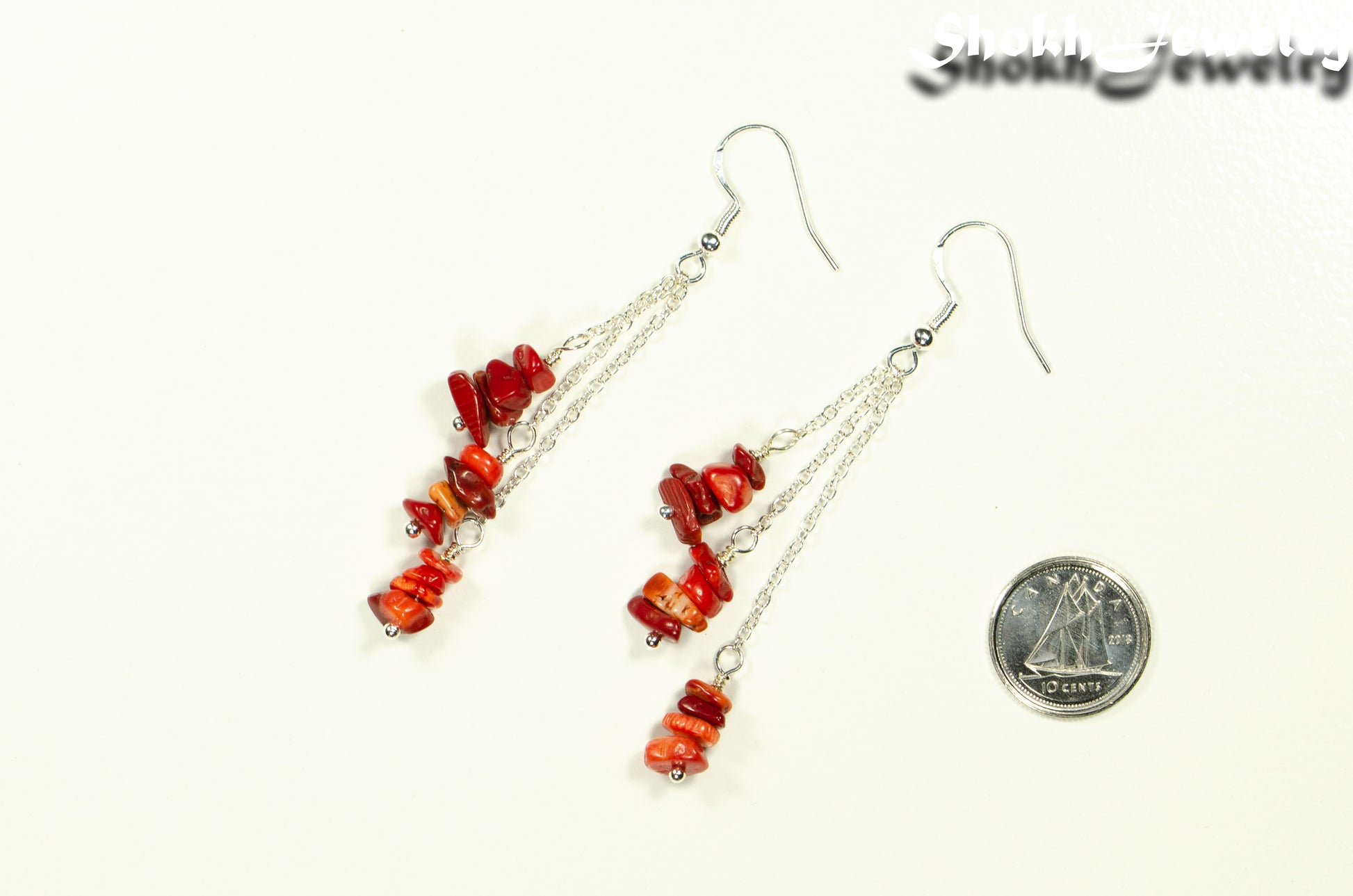 Long Silver Plated Chain and Red Coral Chip Earrings beside a dime.