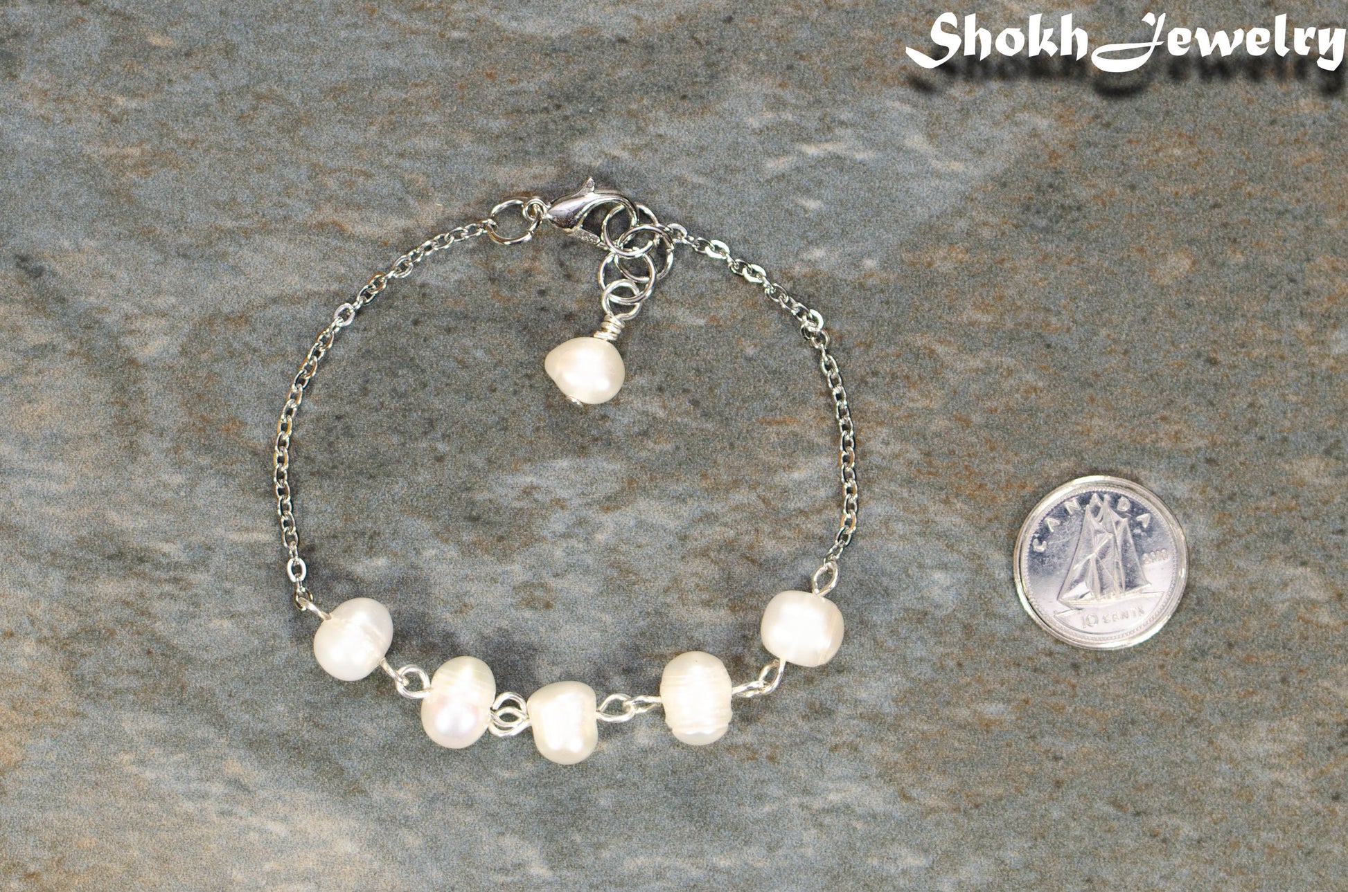 Freshwater Pearl and Stainless Steel Chain Anklet beside a dime.