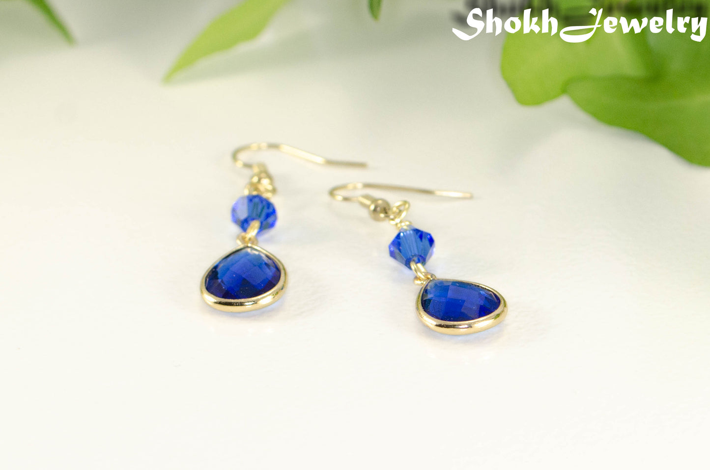 Blue Glass Teardrop Dangle Earrings with gold tone ear wires.