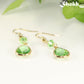 Green Glass Teardrop Dangle Earrings with gold tone ear wires.