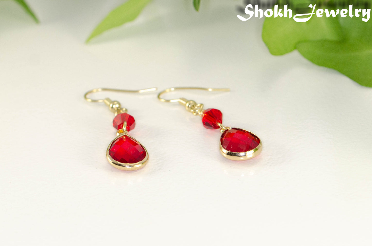 Red Glass Teardrop Dangle Earrings with gold tone ear wires.