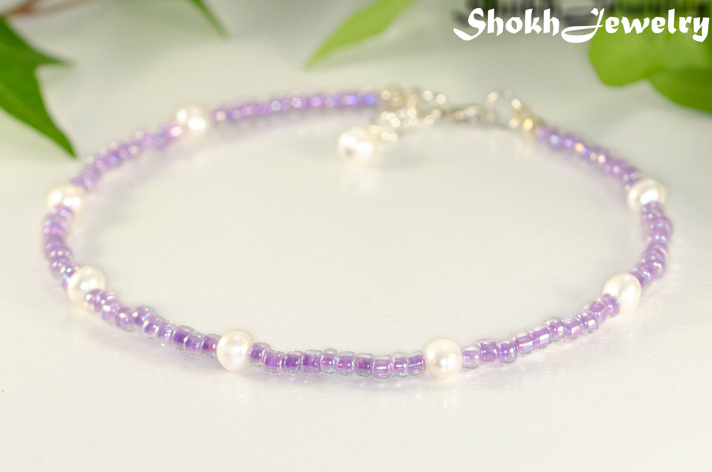Close up of Freshwater Pearl and Purple Seed Bead Anklet.
