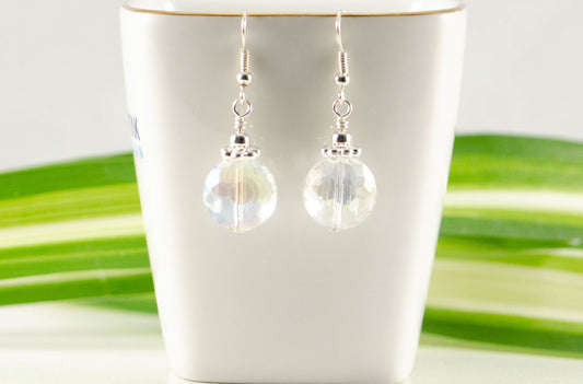 Clear AB Glass Crystal Beads Earrings displayed on a tea cup.