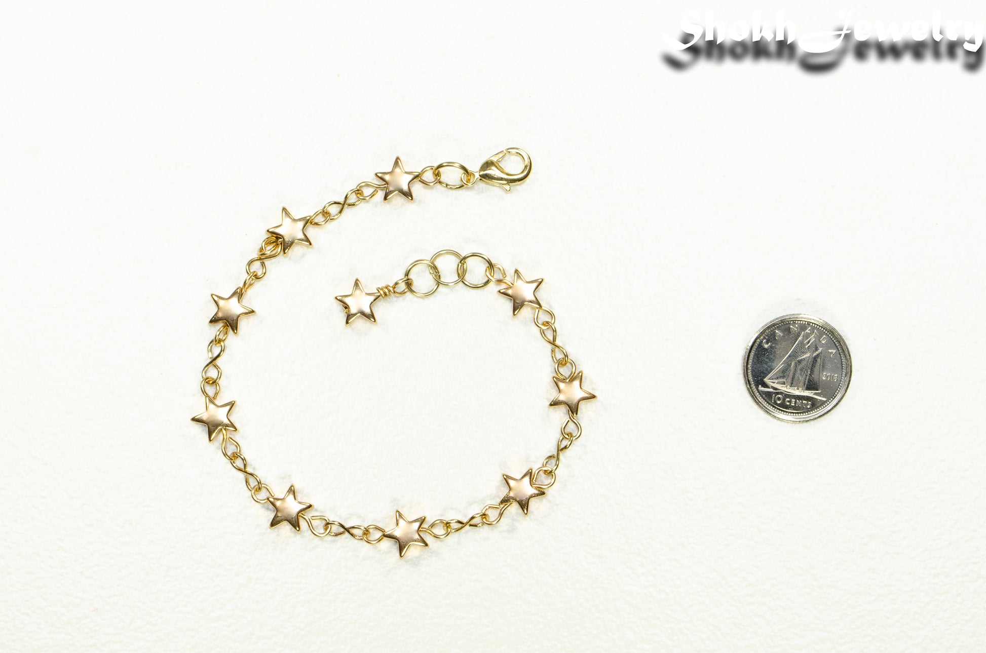 Gold plated Hematite Star Link Bracelet beside a dime