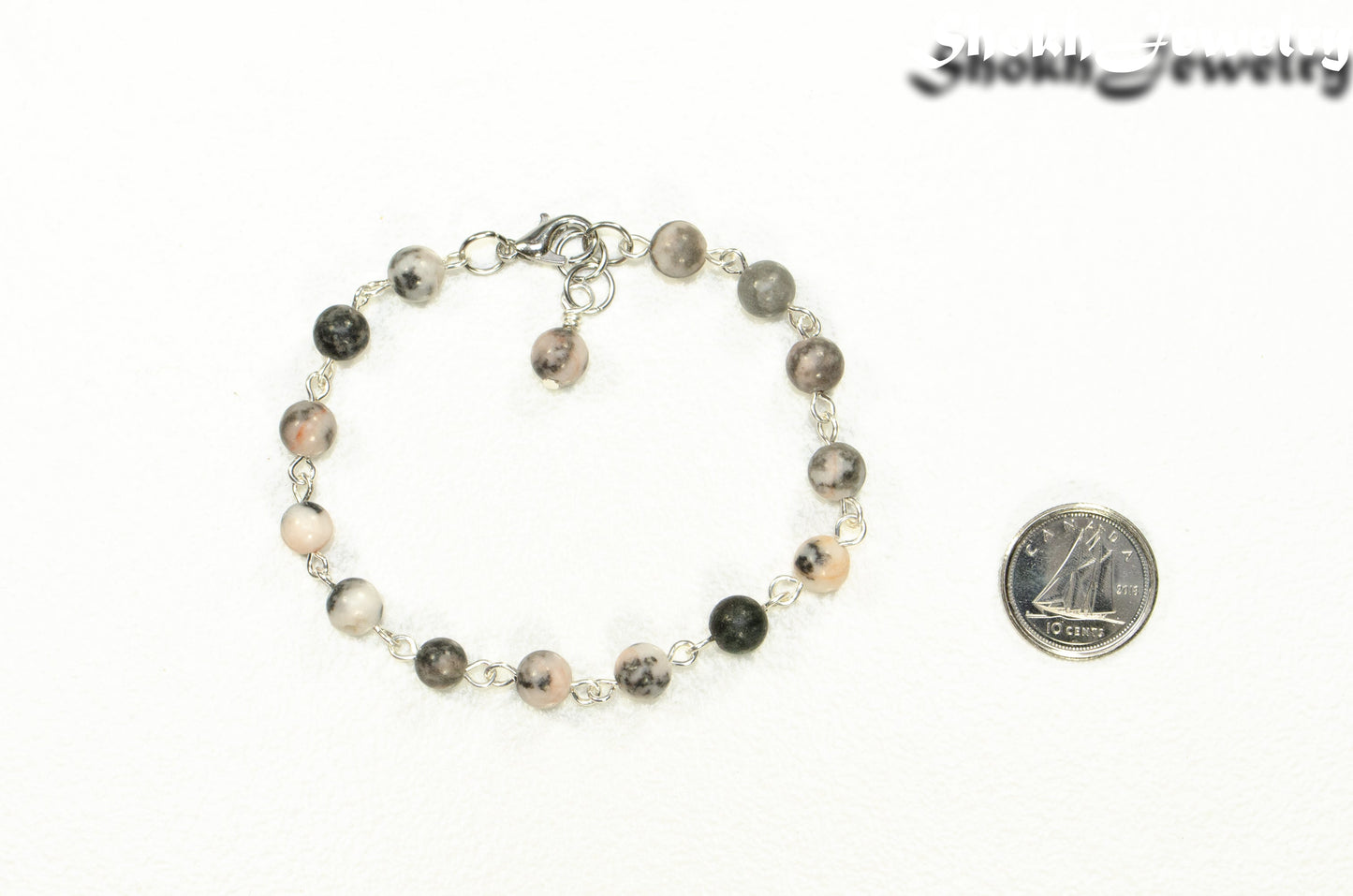 Handmade Pink Zebra Jasper Link chain anklet beside a dime.