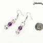 Long Floral Ceramic Bead and Amethyst Earrings beside a dime.