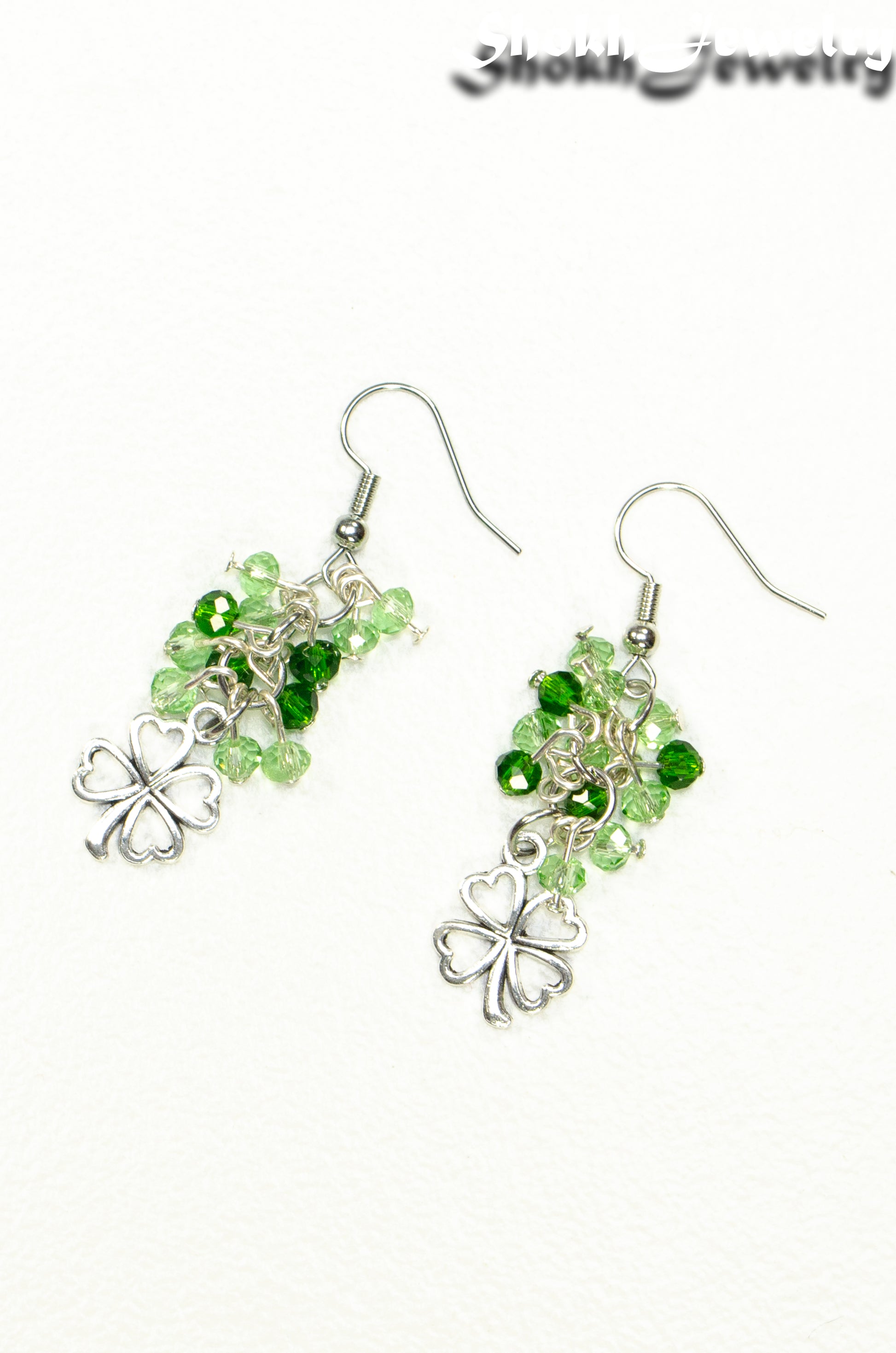 Top view of Lucky Four Leaf Clover Charm and Green Glass Bead Earrings.