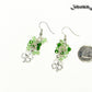 Lucky Four Leaf Clover Charm and Green Glass Bead Earrings beside a dime.