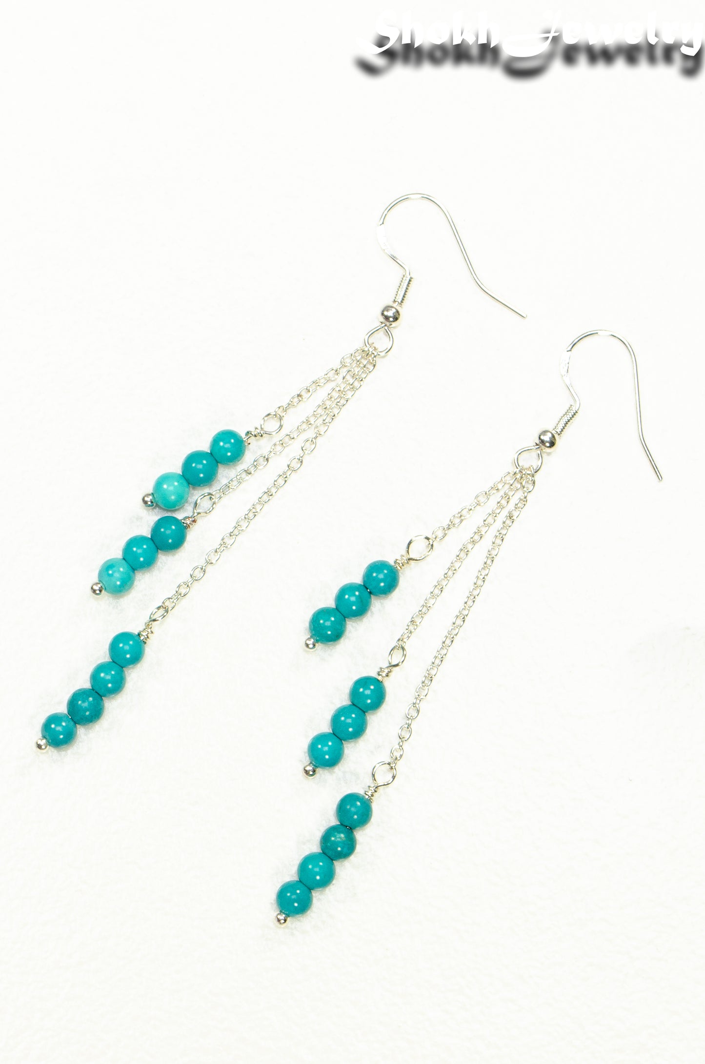 Top view of Silver Plated Chain and Turquoise Earrings.