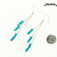 Silver Plated Chain and Turquoise Earrings beside a dime.
