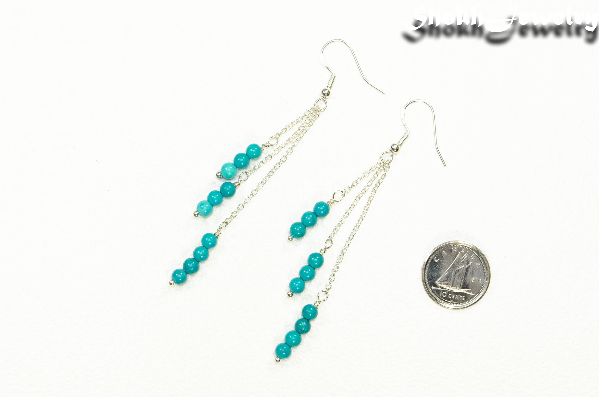 Silver Plated Chain and Turquoise Earrings beside a dime.
