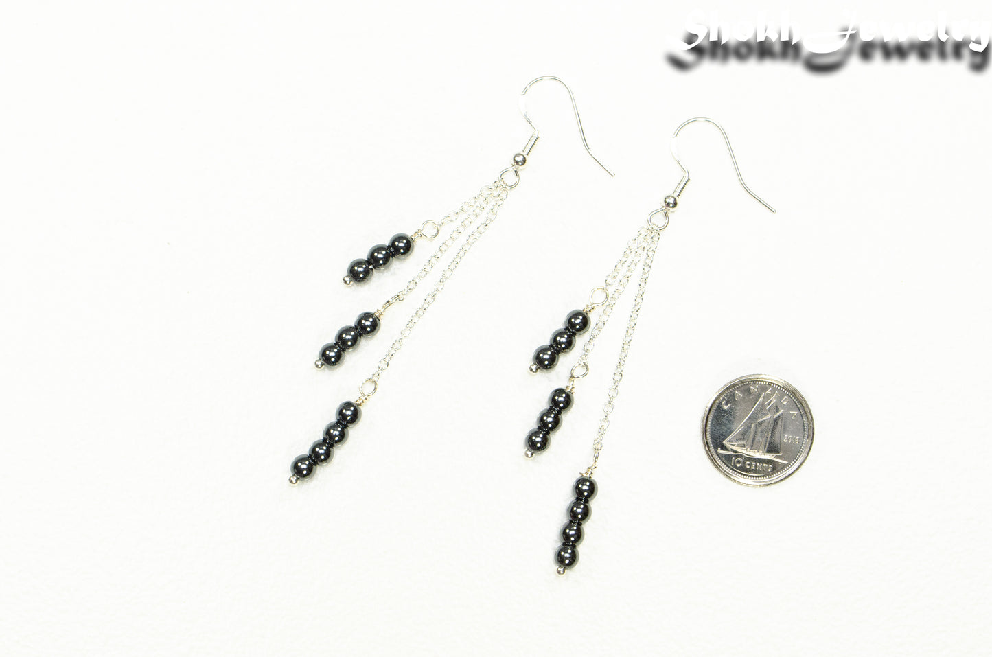 Silver Plated Chain and Natural Hematite Earrings beside a dime.