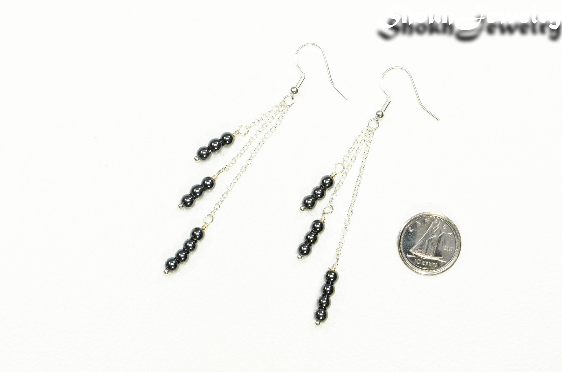 Silver Plated Chain and Natural Hematite Earrings beside a dime.