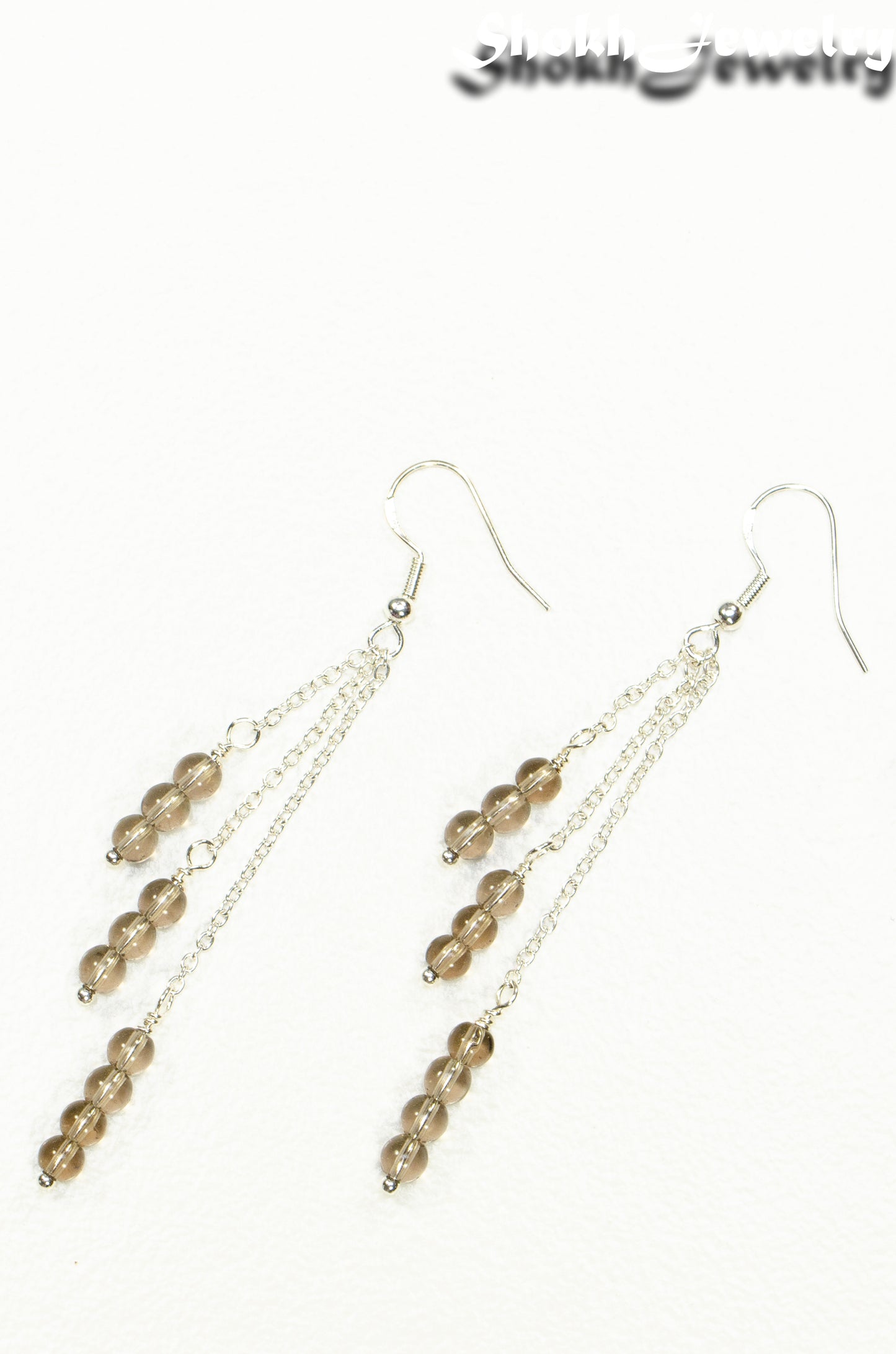 Top view of Silver Plated Chain and Smoky Quartz Crystal Earrings.