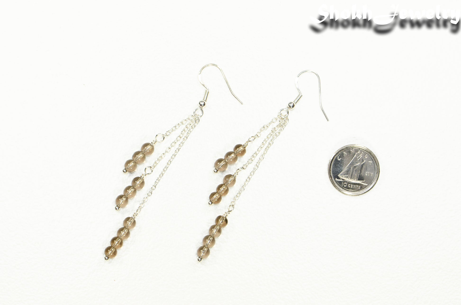 Silver Plated Chain and Smoky Quartz Crystal Earrings beside a dime.