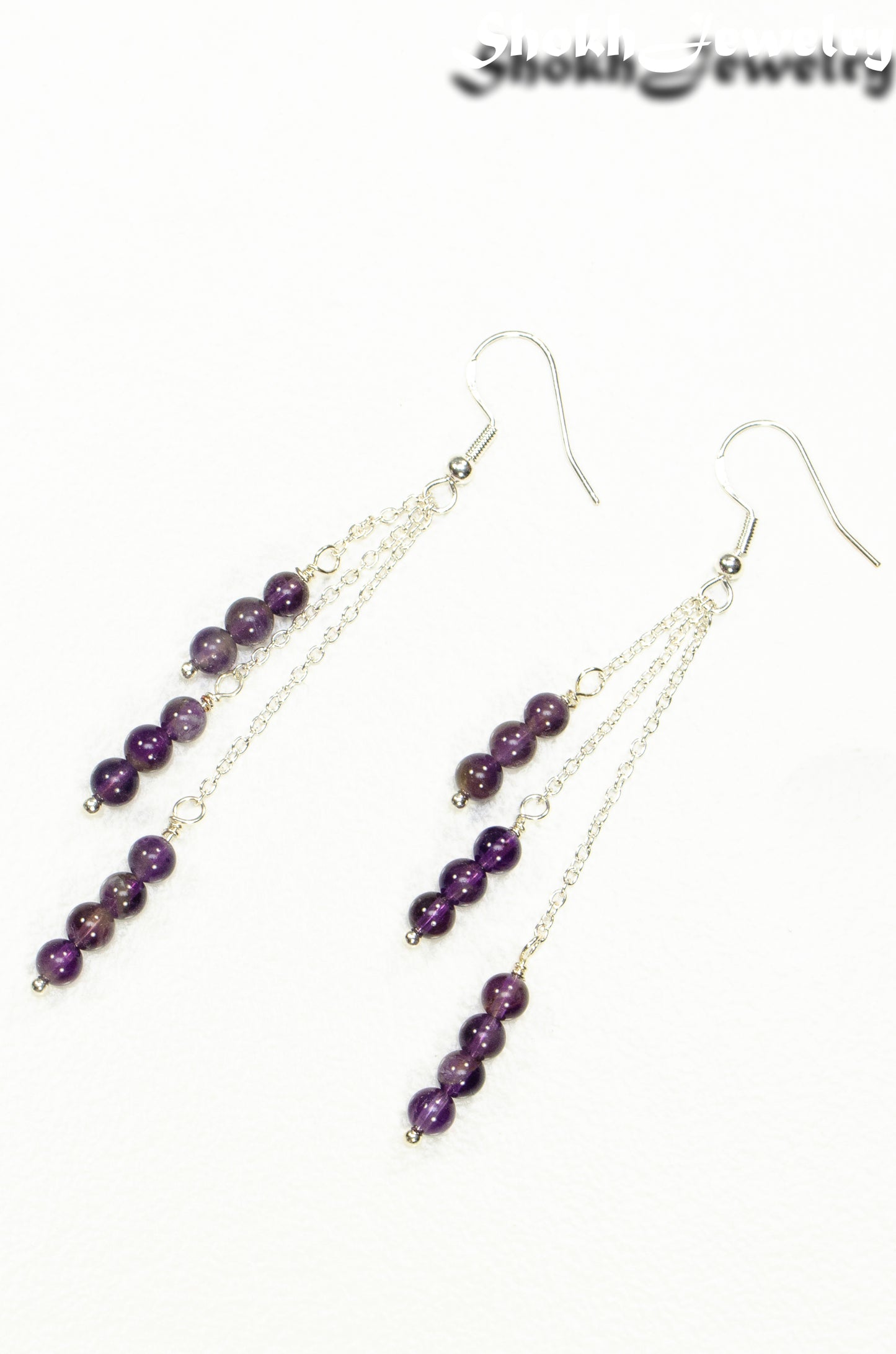 Top view of Silver Plated Chain and Amethyst Crystal Earrings.