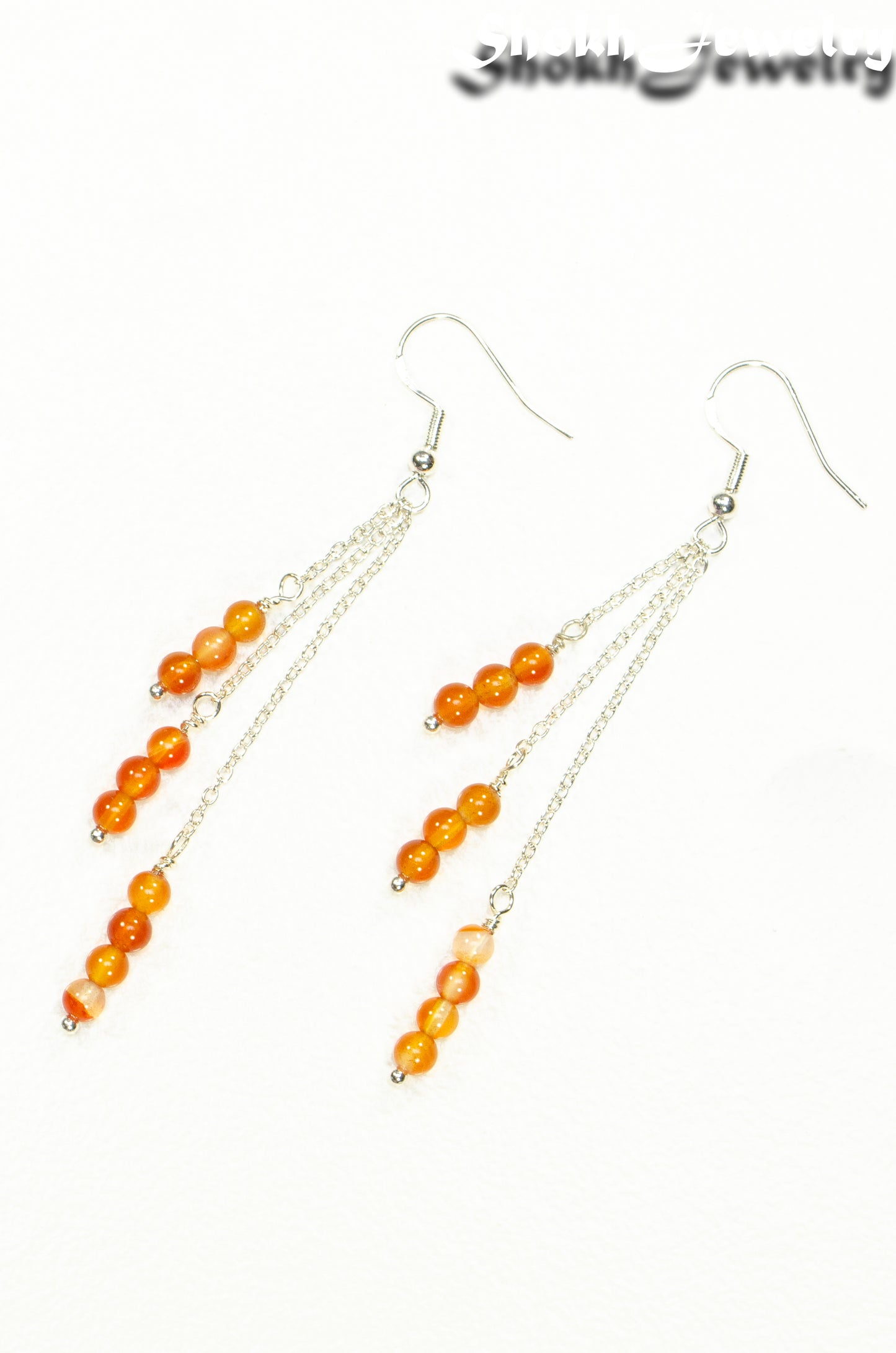 Top view of Silver Plated Chain and Carnelian Crystal Earrings.