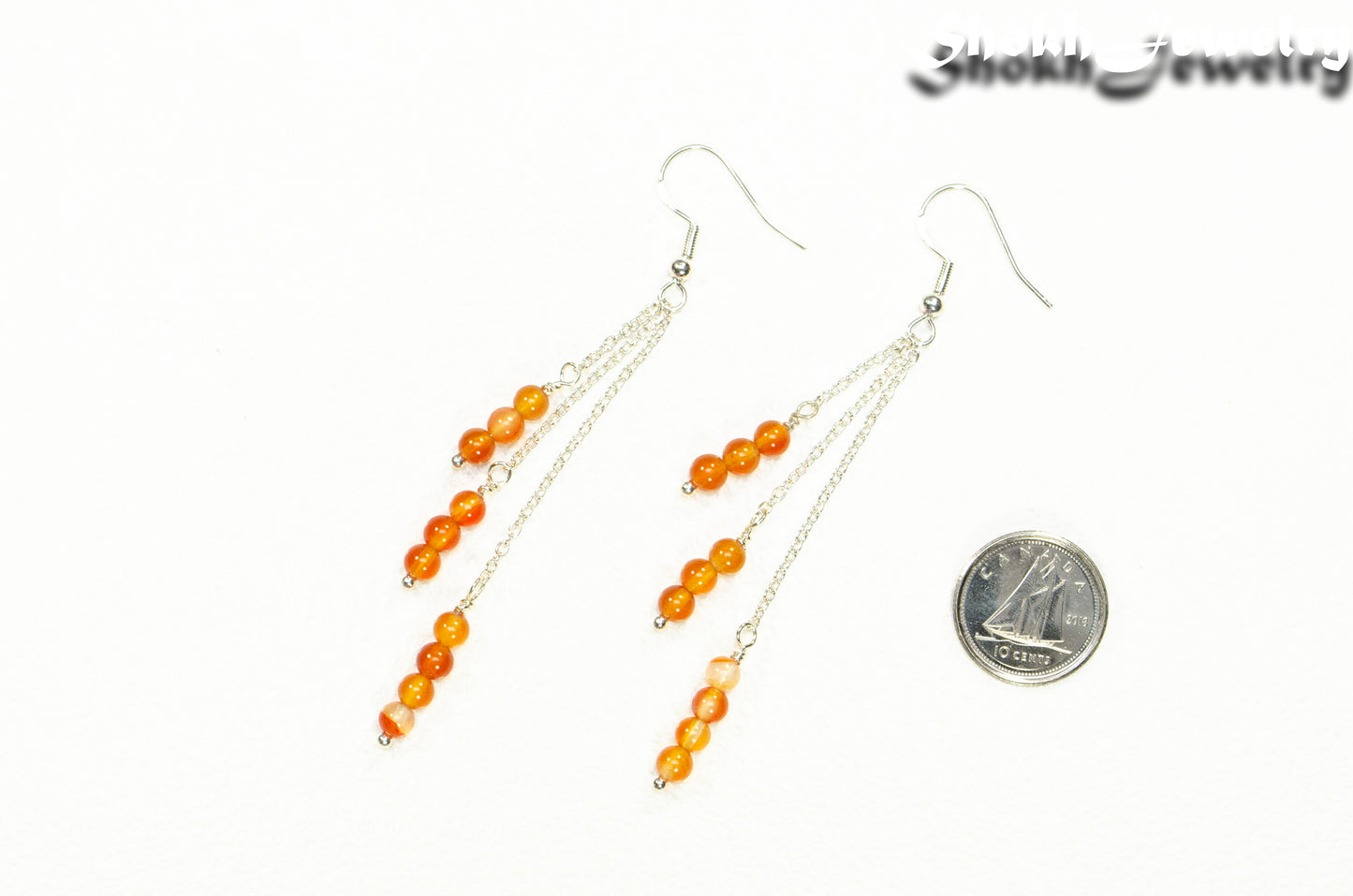 Silver Plated Chain and Carnelian Crystal Earrings beside a dime.