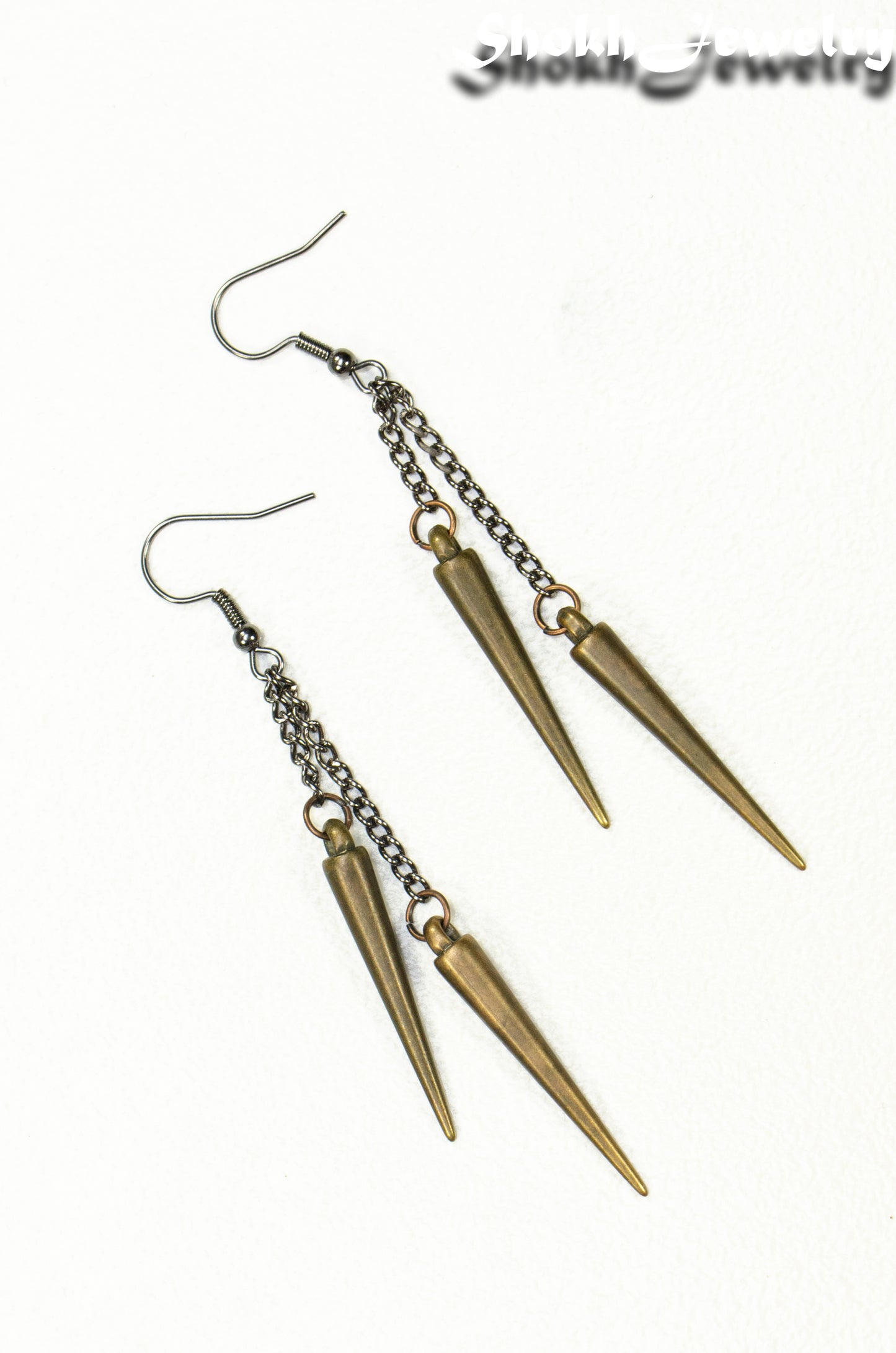 Top view of Long chain and antique bronze spike earrings.