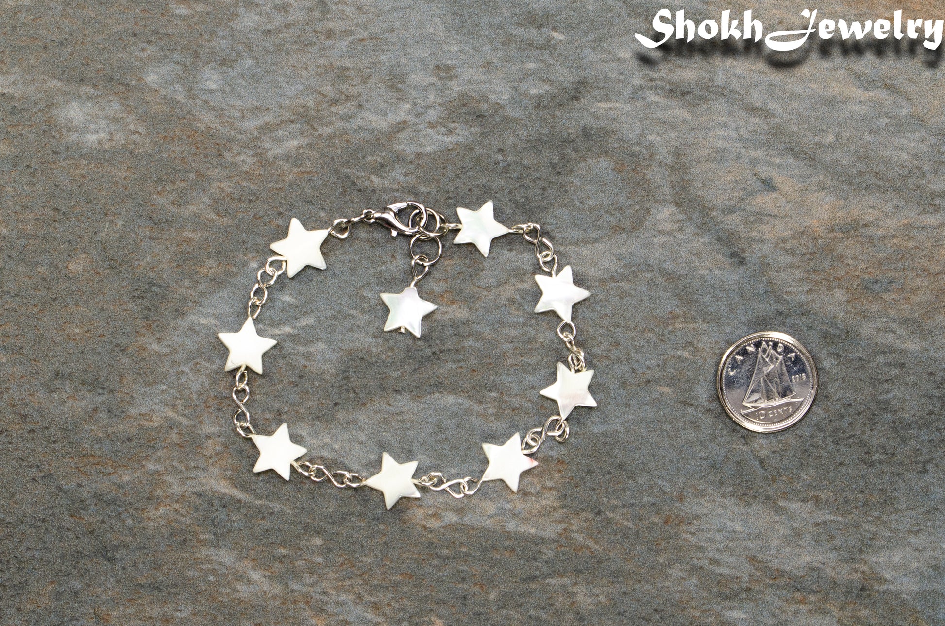 Natural Seashell Star Link Bracelet beside a dime.