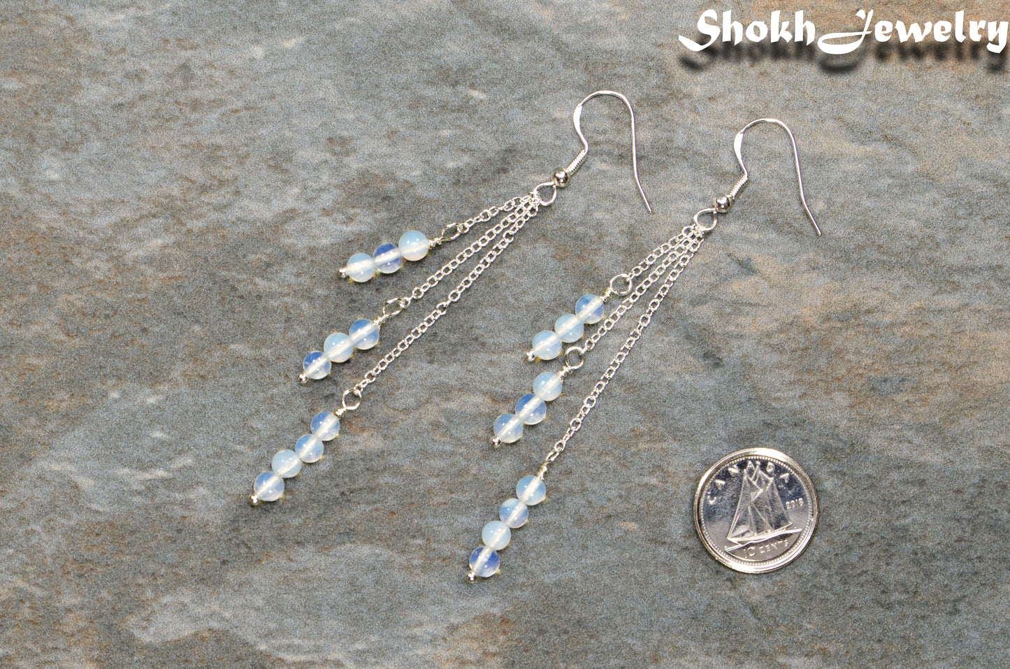 Silver Plated Chain and White Opal Crystal Earrings beside a dime.