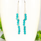 Close up of Silver Plated Chain and Turquoise Earrings.