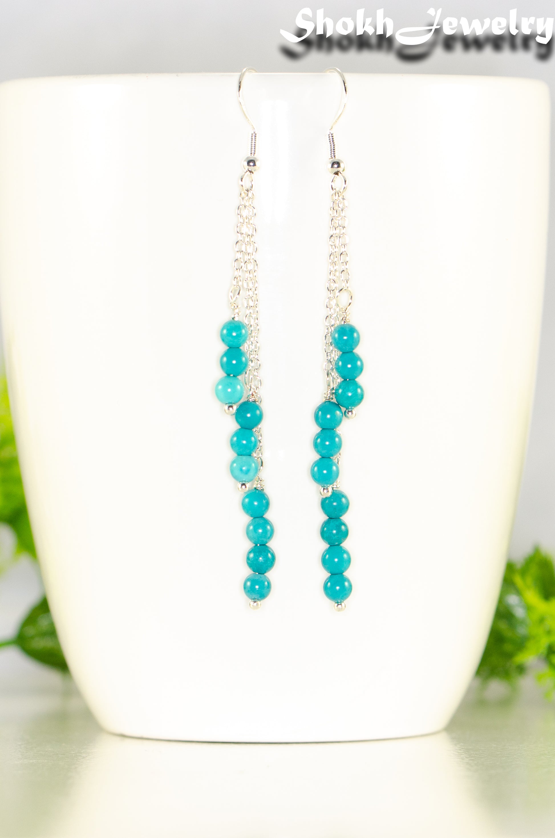 Close up of Silver Plated Chain and Turquoise Earrings.