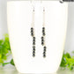 Silver Plated Chain and Natural Hematite Earrings displayed on a coffee mug.