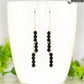 Silver Plated Chain and Black Onyx Stone Earrings displayed on a coffee mug.