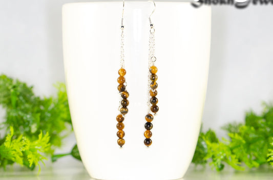 Silver Plated Chain and Tiger's Eye Stone Earrings displayed on a coffee mug.