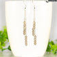 Silver Plated Chain and Smoky Quartz Crystal Earrings displayed on a coffee mug.