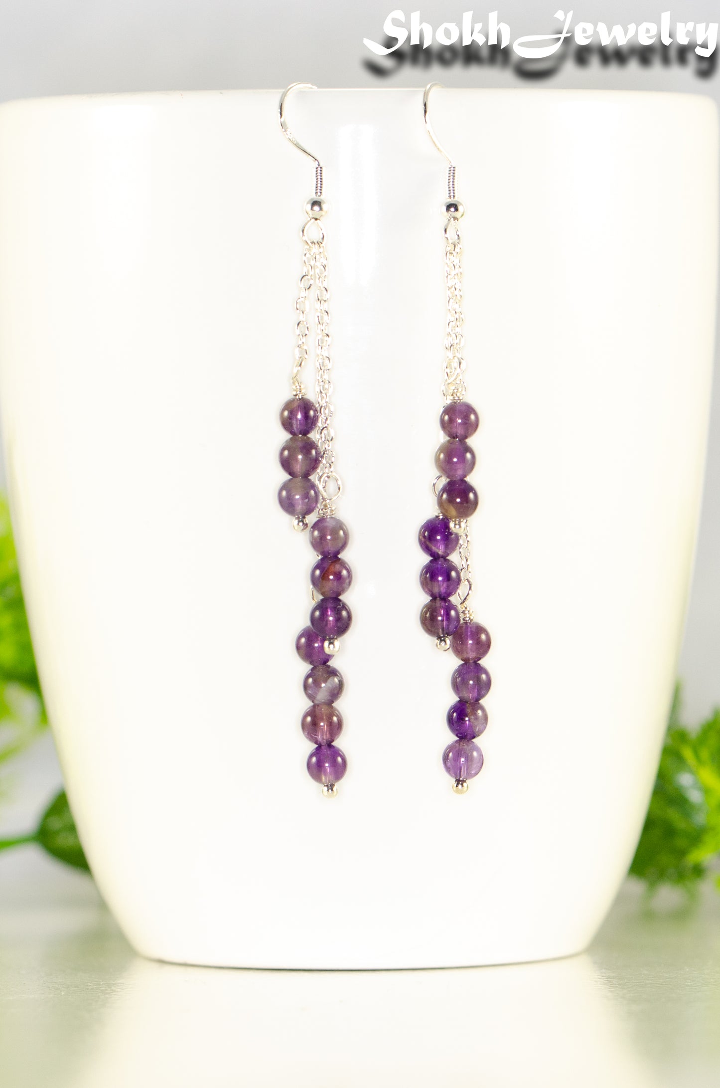 Close up of Silver Plated Chain and Amethyst Crystal Earrings.