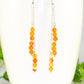 Close up of Silver Plated Chain and Carnelian Crystal Earrings.