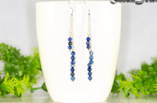 Silver Plated Chain and Lapis Lazuli Stone Earrings displayed on a coffee mug.