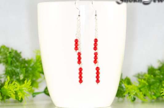 Silver Plated Chain and Red Coral Earrings displayed on a coffee mug.