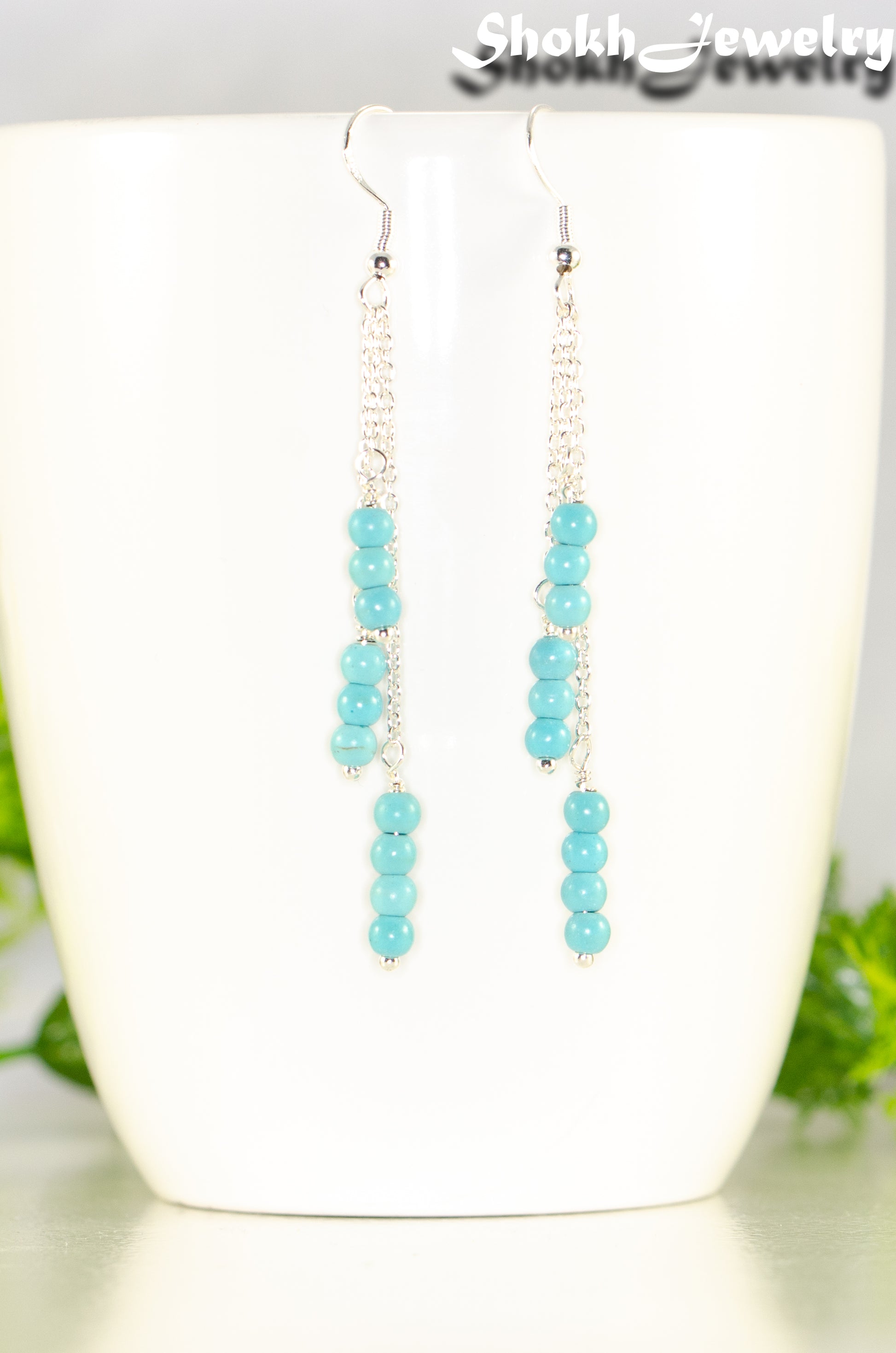 Close up of Silver Plated Chain and Turquoise Howlite Earrings.