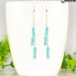 Silver Plated Chain and Turquoise Howlite Earrings displayed on a coffee mug.