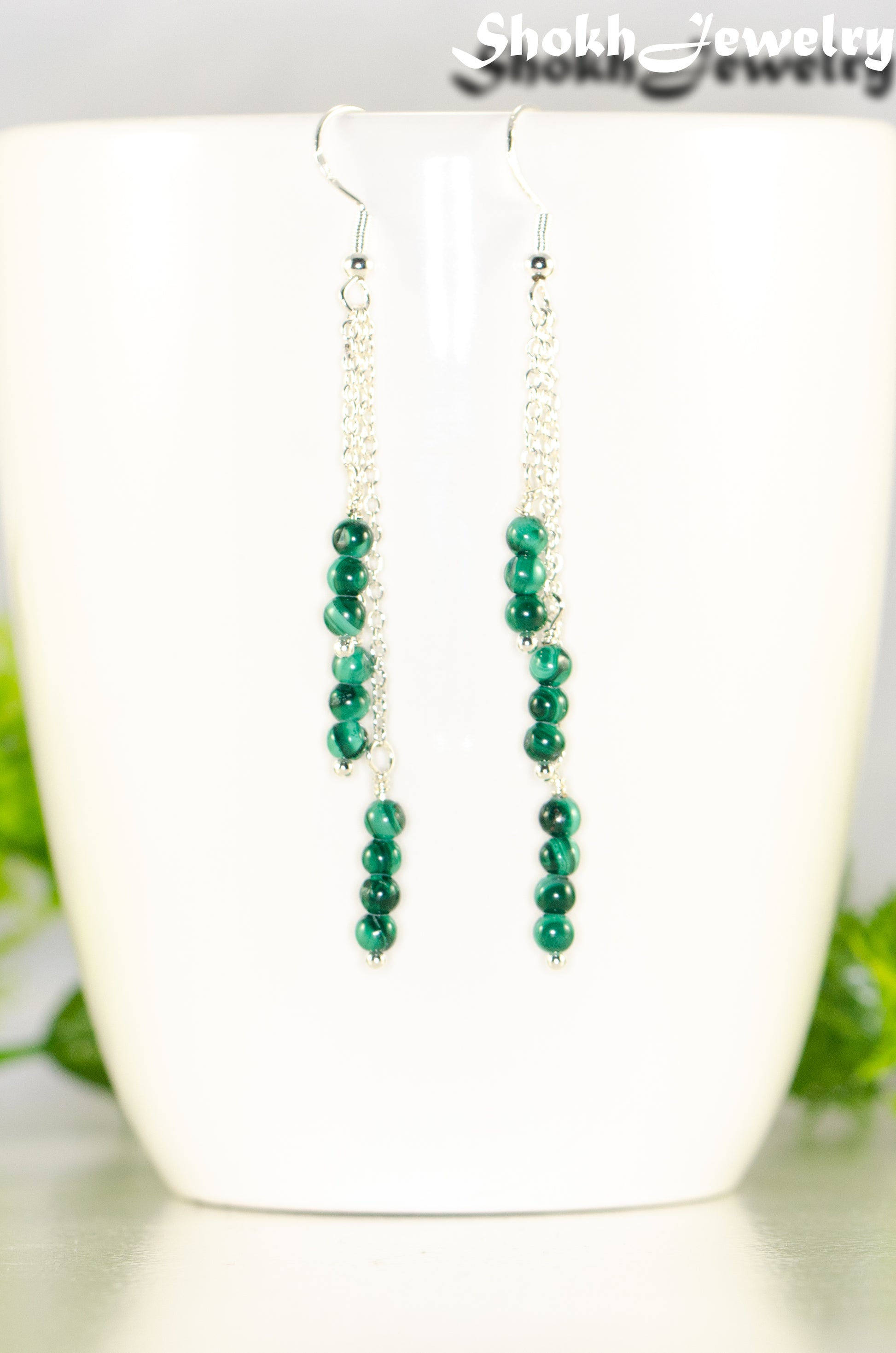 Close up of Silver Plated Chain and Malachite Stone Earrings.