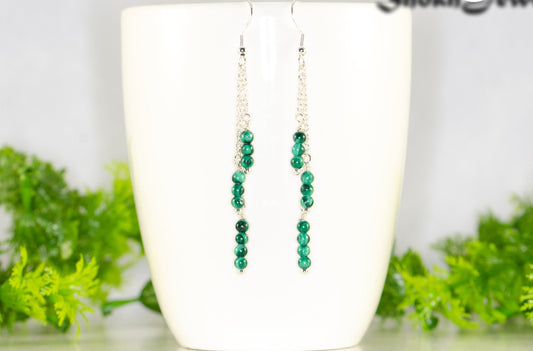 Silver Plated Chain and Malachite Stone Earrings displayed on a coffee mug.