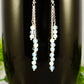 Close up of Silver Plated Chain and White Opal Crystal Earrings.