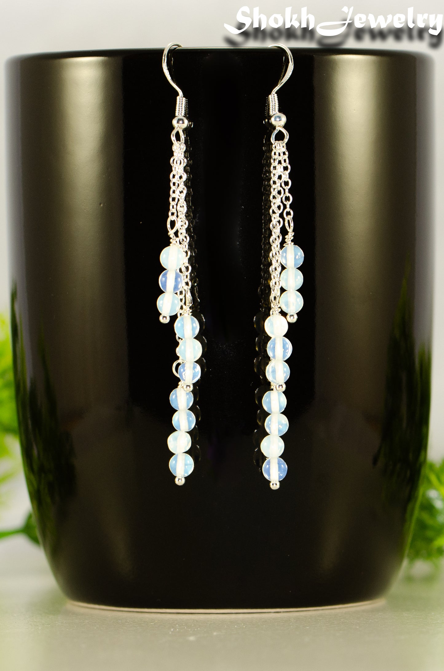 Close up of Silver Plated Chain and White Opal Crystal Earrings.