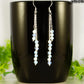 Silver Plated Chain and White Opal Crystal Earrings displayed on a coffee mug.