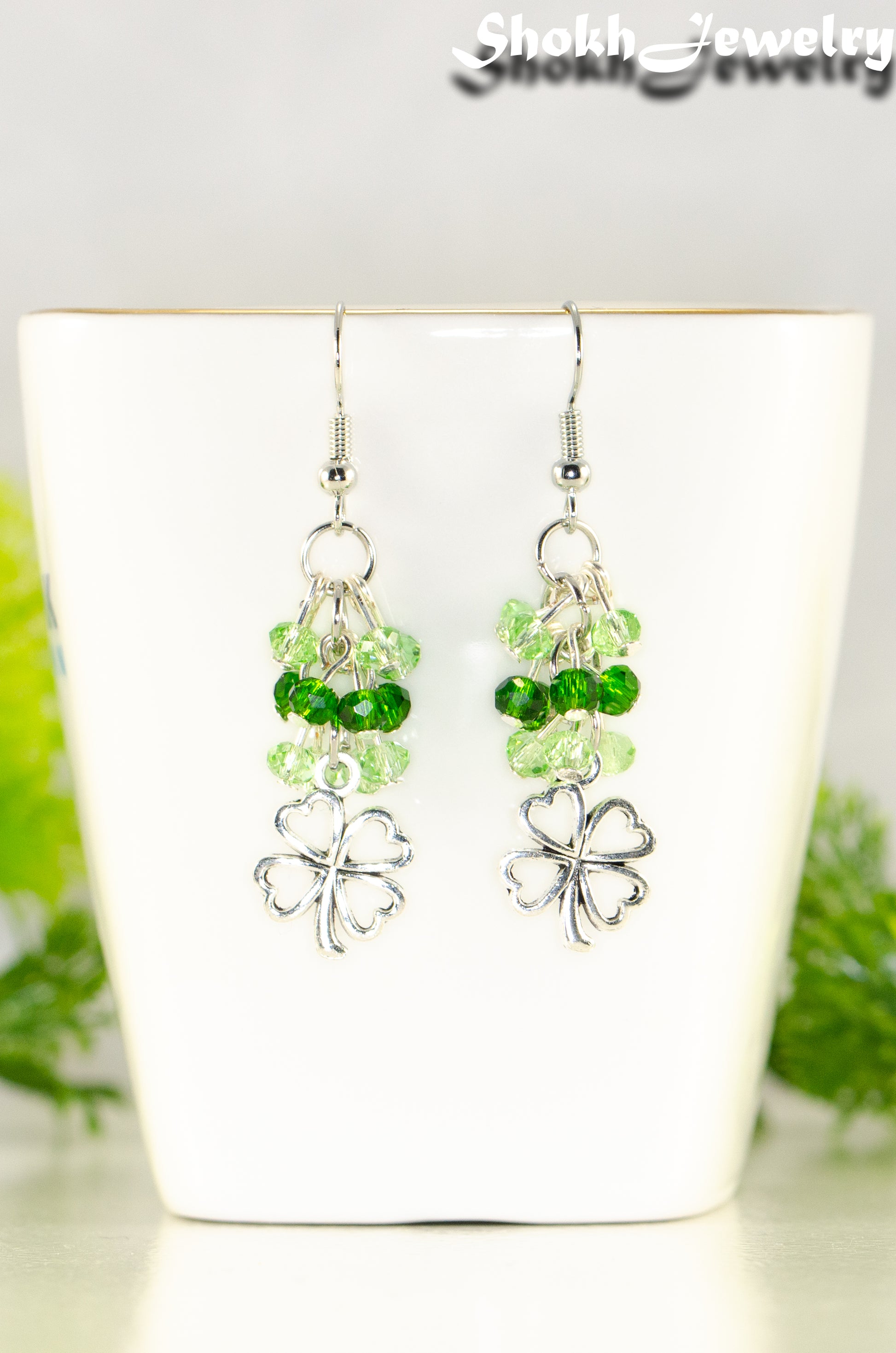 Close up of Lucky Four Leaf Clover Charm and Green Glass Bead Earrings.