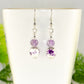 Close up of Small Floral Ceramic Bead and Amethyst Earrings.