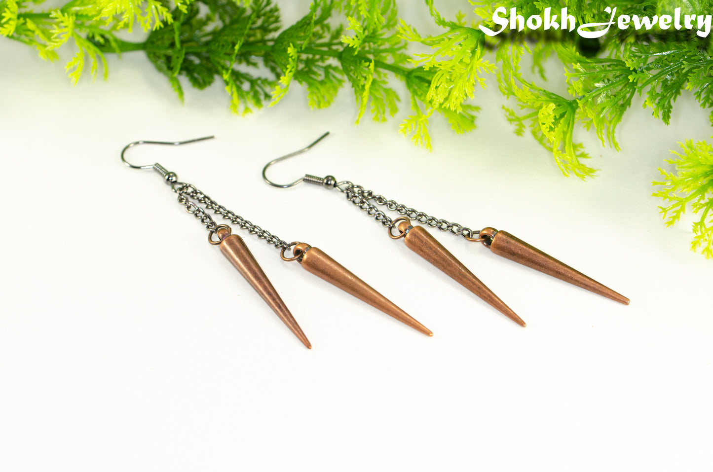 Long chain and antique copper spike earrings.