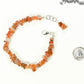 Natural Carnelian Crystal Chip Bracelet beside a dime.