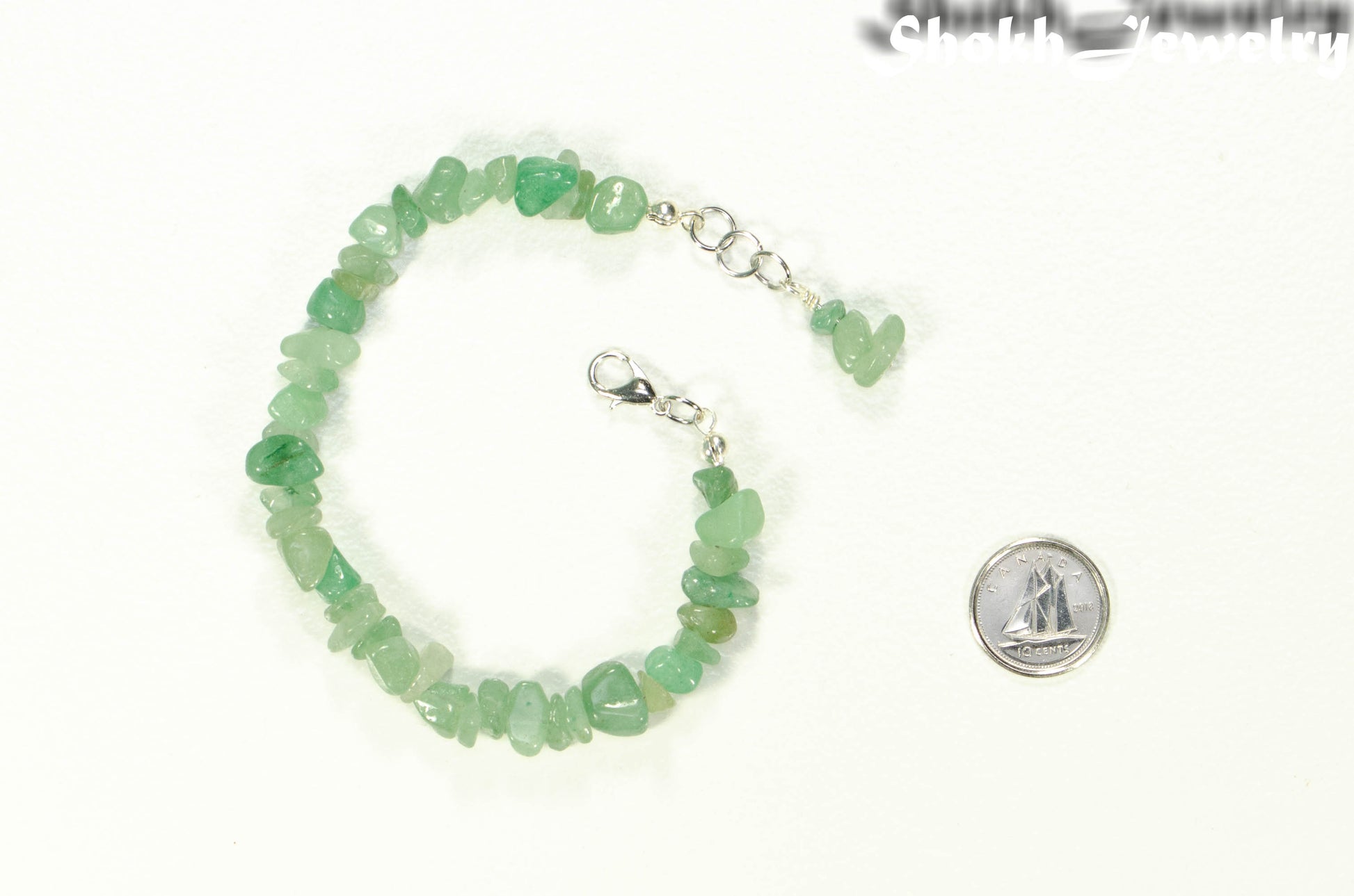 Natural Green Aventurine Crystal Chip Bracelet beside a dime.