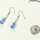 Small Light Blue Glass Bead Dangle Earrings beside a dime.